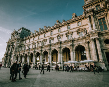 tourists gather outside le louvre