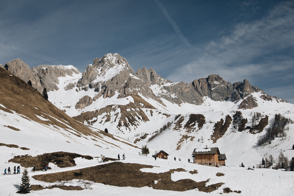 tourists head back to snowy log cabins