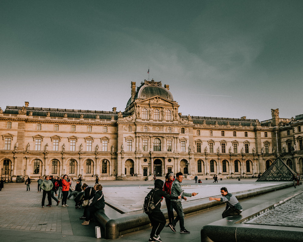 tourists snapping pics outside the louvre