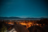 town looks out to snow capped mountains and a starry sky