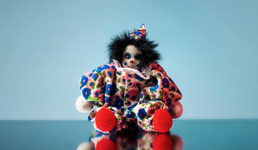 toy clown doll sits on mirror