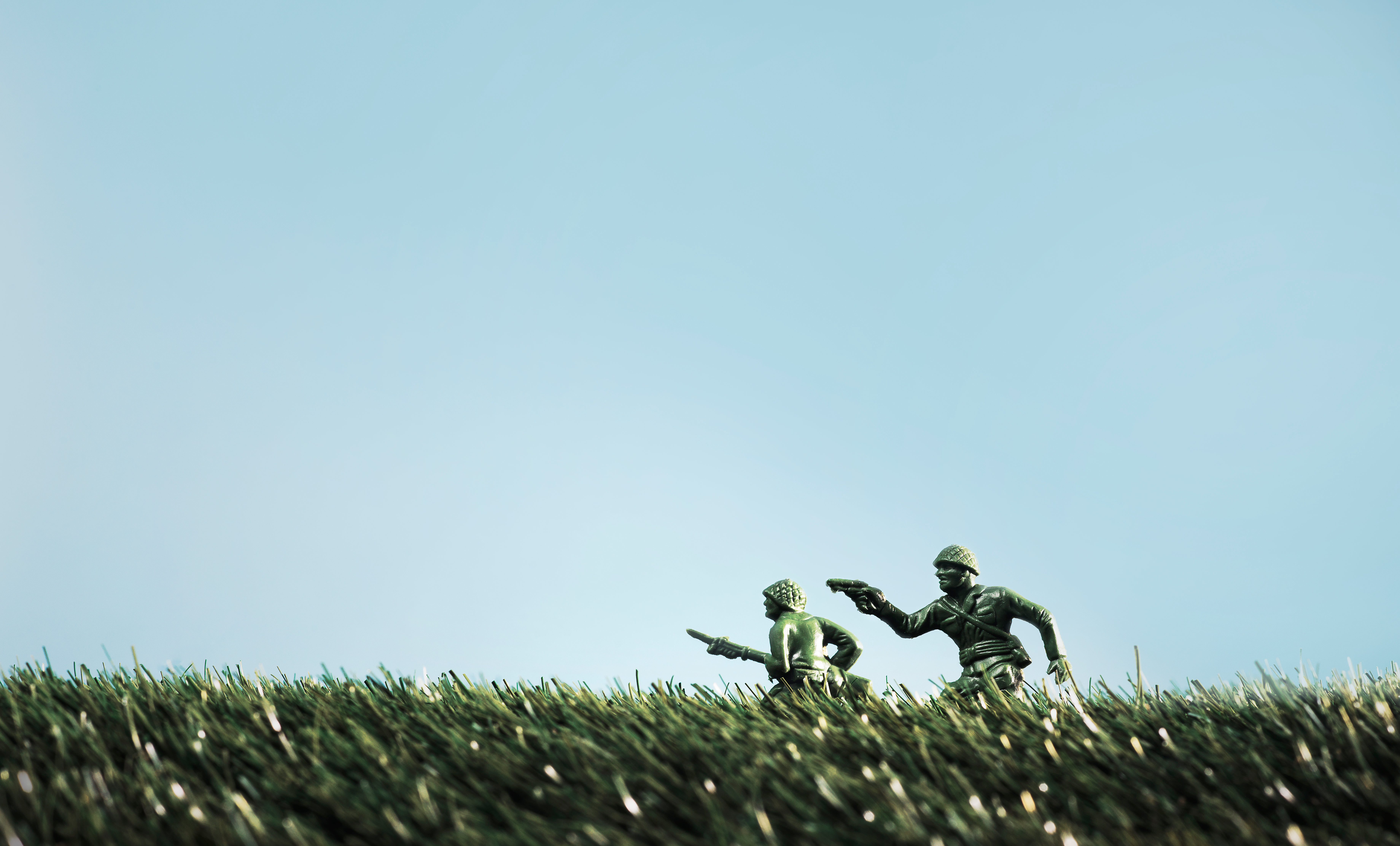 Toy Soldiers Run Through Tall Grass