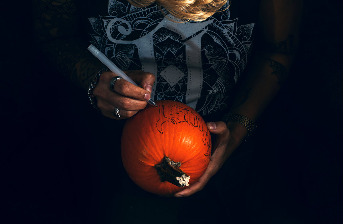 tracing a design onto a pumpkin