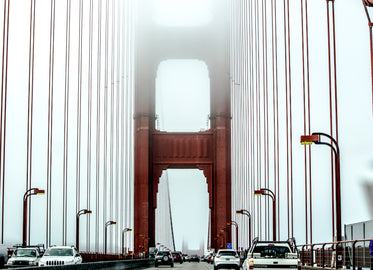 traffic on a suspension bridge suspended in mist