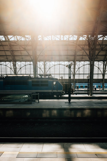 train station with two blue trains waiting