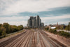 train tracks split where tall city buildings stand