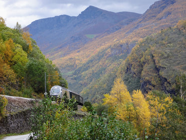 train on tracks through mountains