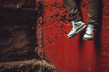 trainers in front of red wall