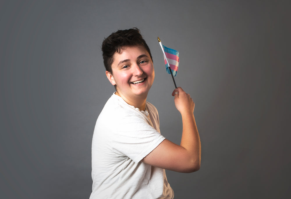 trans man holding trans pride flag