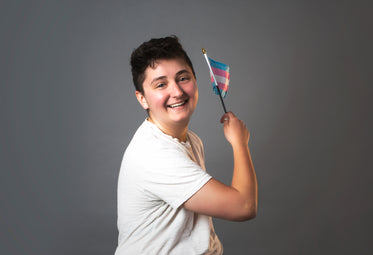trans man holding trans pride flag