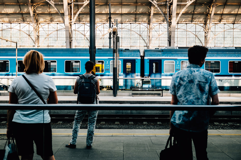 travelers wait for the train to arrive