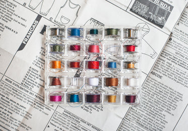 tray of colorful thread bobbins