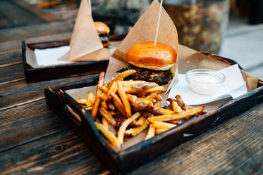 tray with fried a burger and a glass ramekin