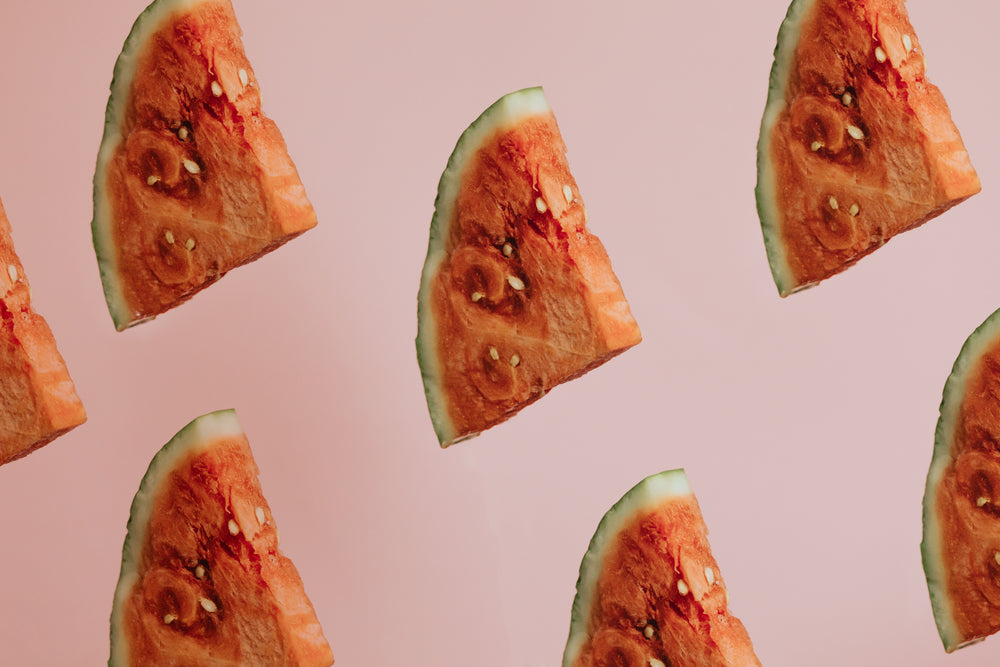 triangle slices of watermelon on pink background