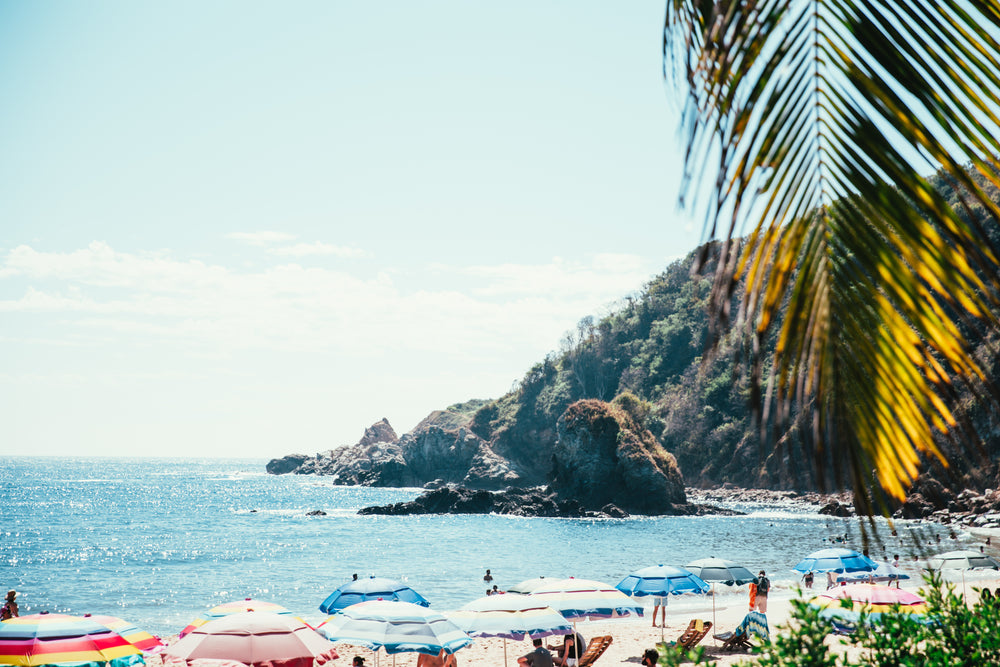 tropical beach below cliff