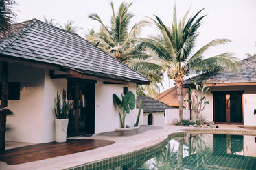 tropical pool outside a white house