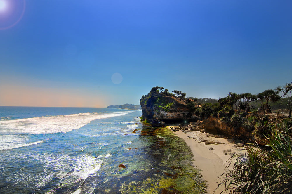 tropical sandy beach surrounded by red cliffs