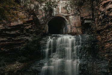 tunnel opens out to waterfall