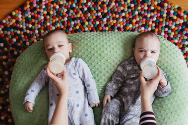 twins on beanbag getting fed