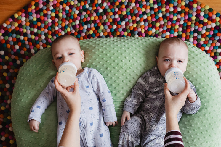 Twins On Beanbag Getting Fed