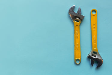 two adjustable wrenches on a blue background