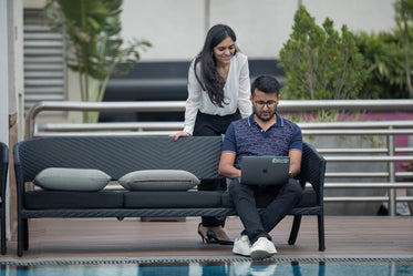 two colleagues working together by the pool