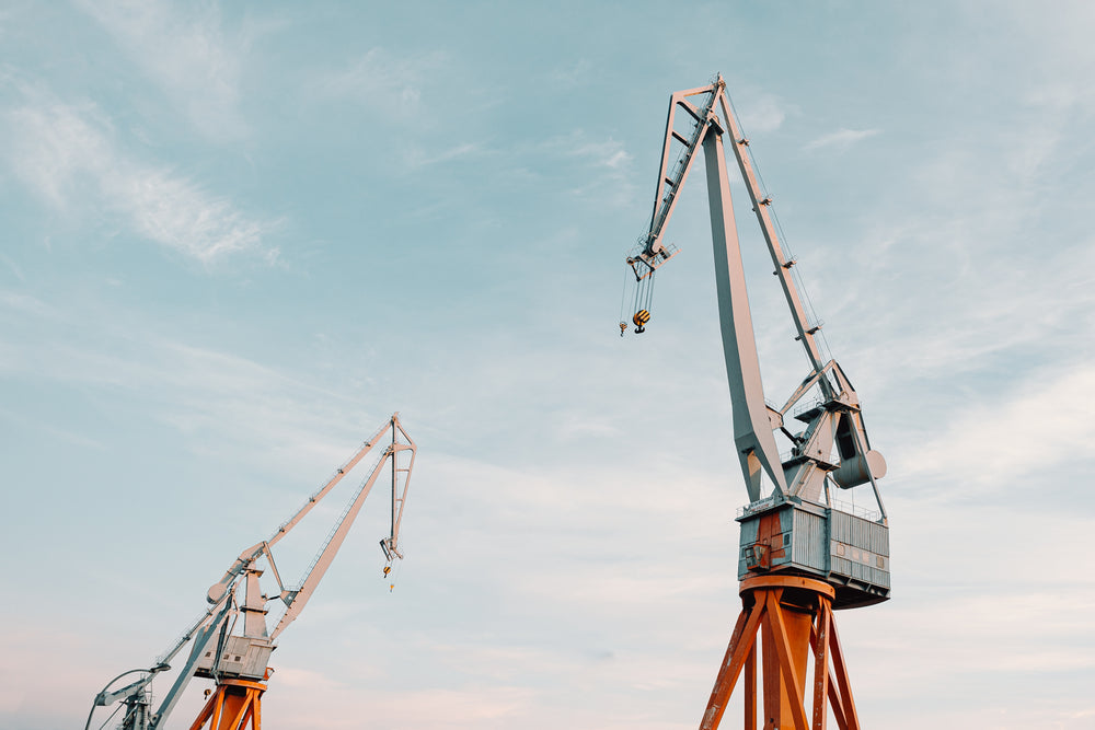 two cranes against a blue sky