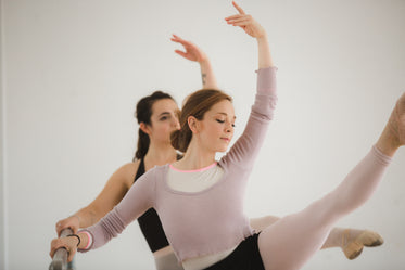 two dancers kick high