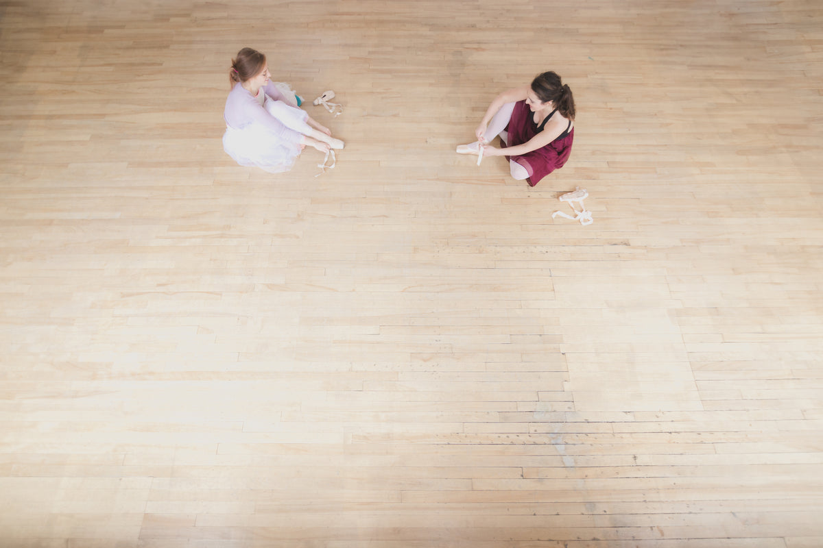 two dancers prepare for ballet