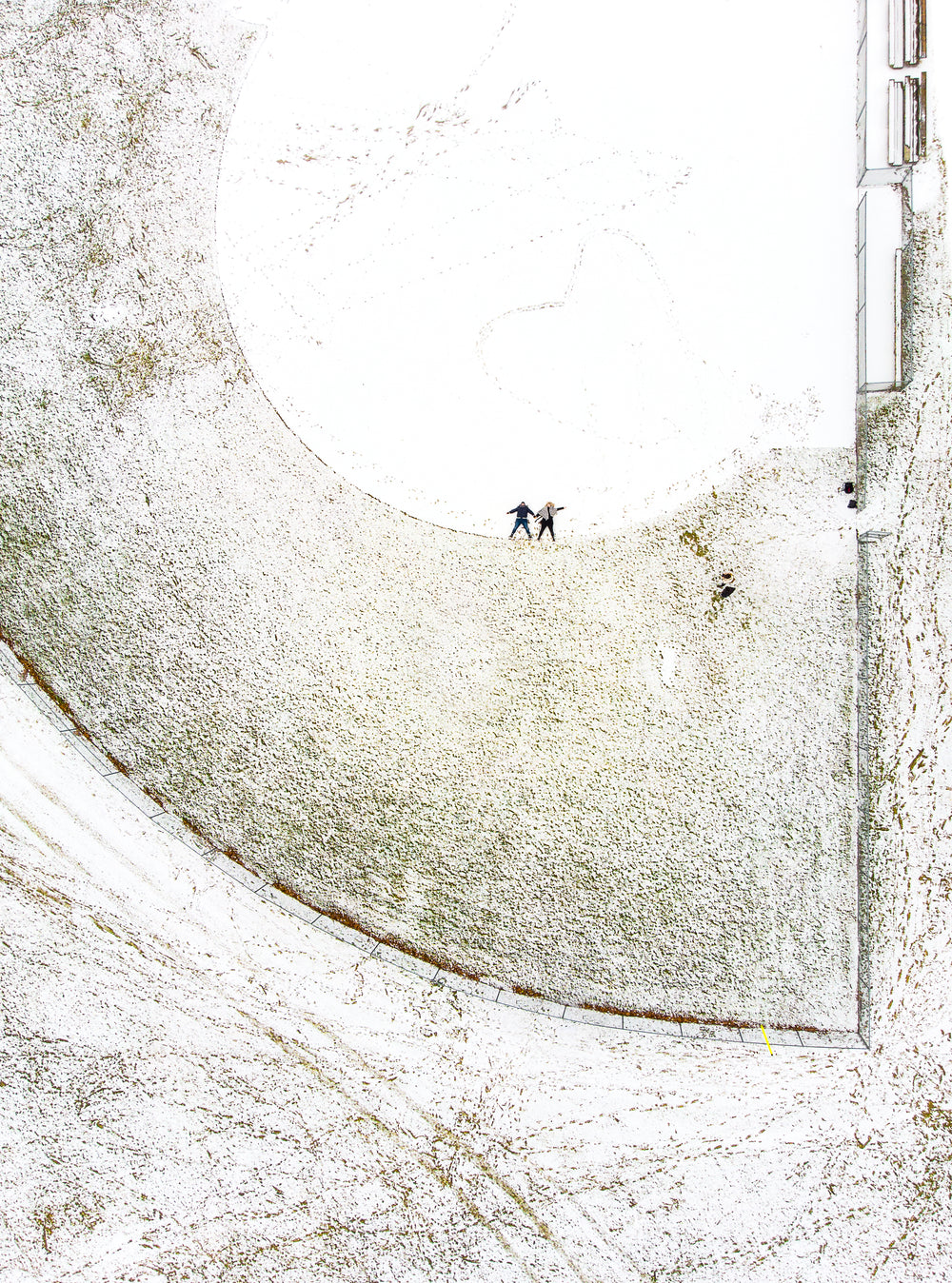 two figures framed by circles in the snow