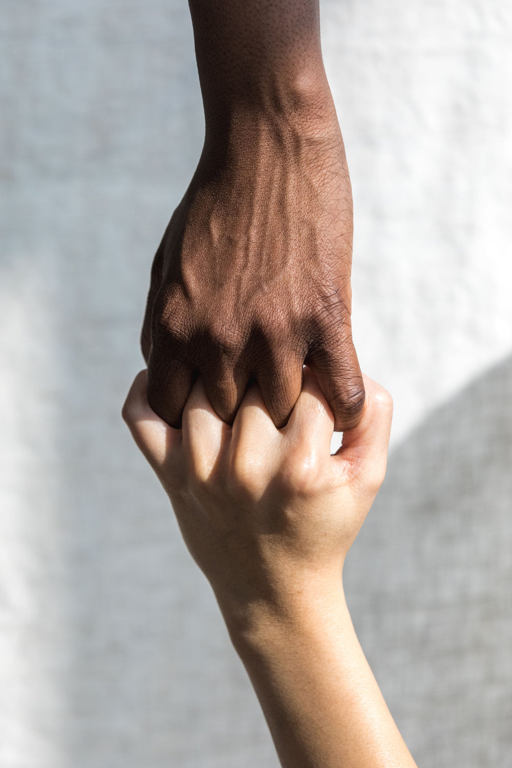 two hands grasping each other in solidarity