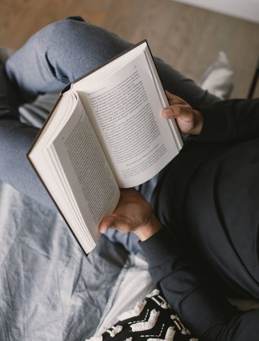 two hands hold a book open to read