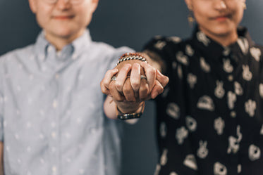 two hands interlocked shallow depth