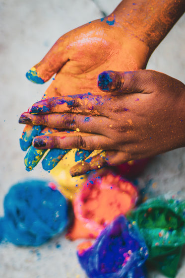 two hands rubbing powdered paint