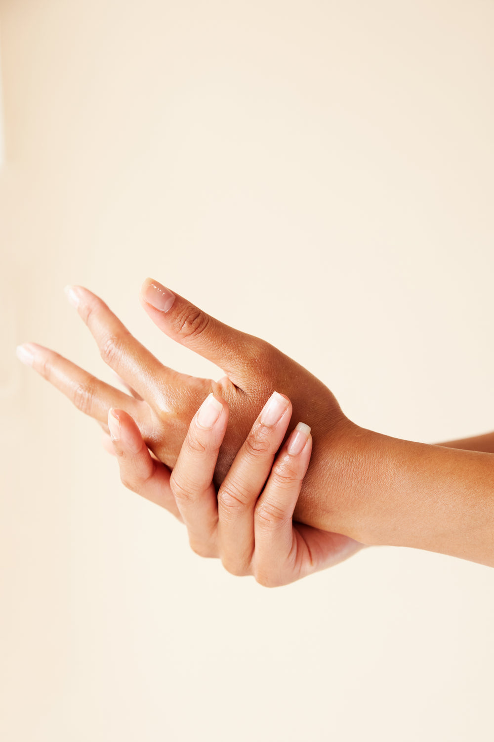 duas mãos fazendo tratamento de pele