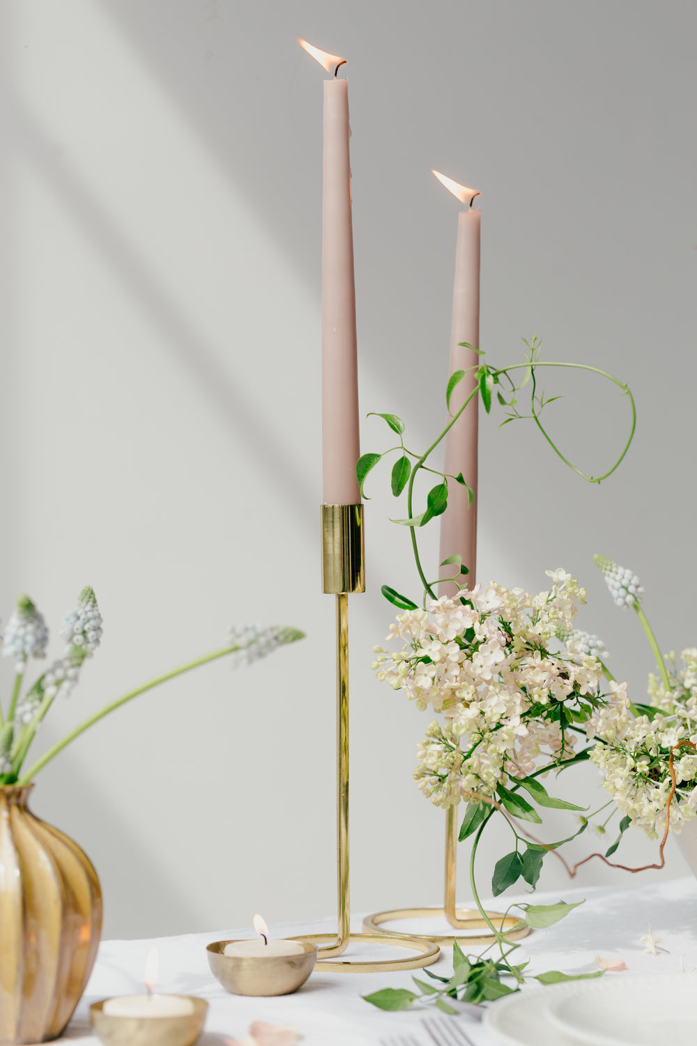 two mauve candles on a table