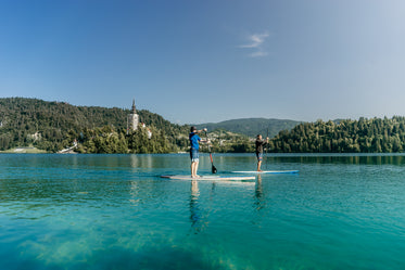 two paddleboarders on aqua blue water