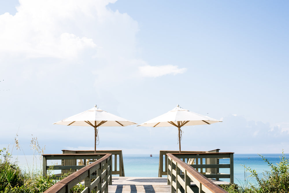 two parasols next to each other on a boardwalk