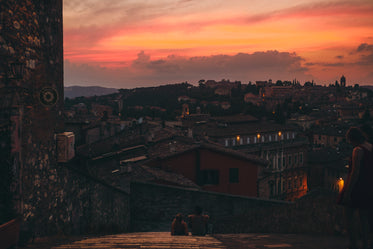 two people on a roof together taking in the sunset