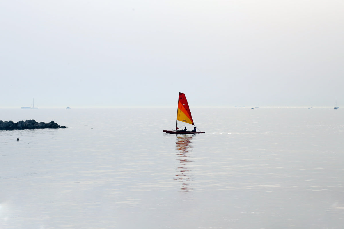 two people on a small boat in the center of frame