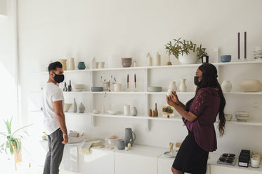 two people shop for pottery