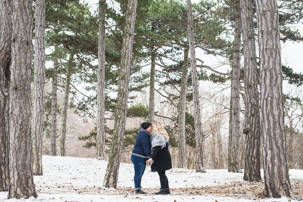 two people smile at each other while holding hands