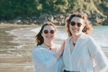 two people stands together on a beach