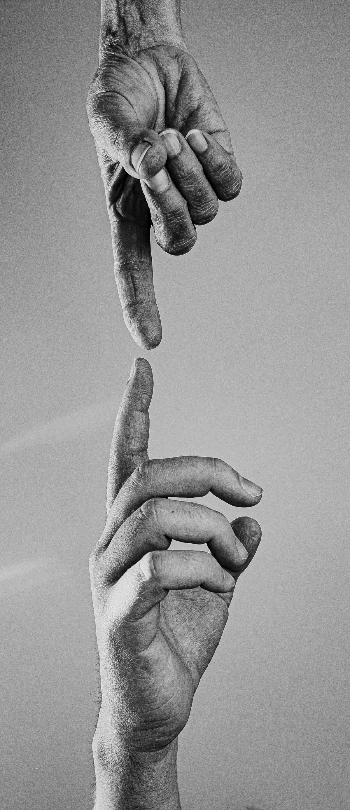 two reaching hands in black and white