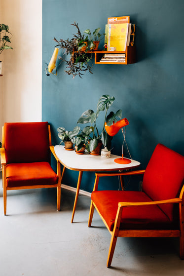 two red chairs near white table