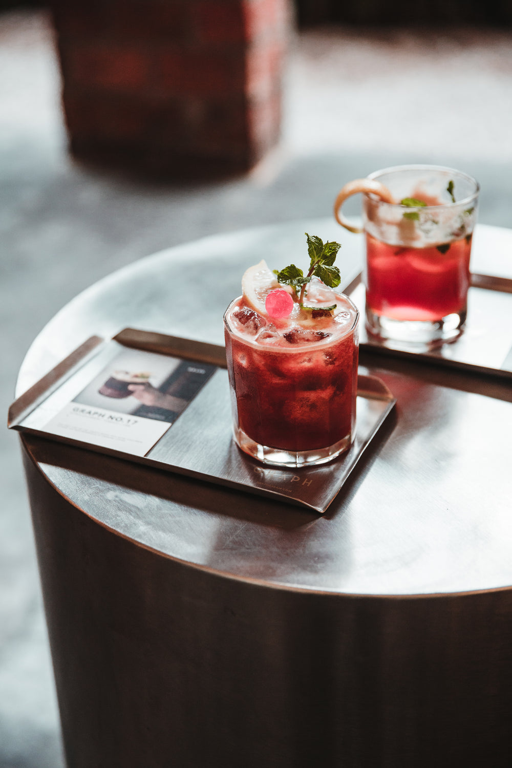 two red cocktails on a tray