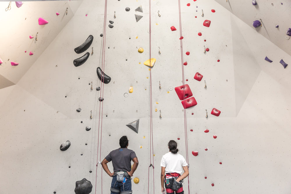 two rock climbers plan their route together