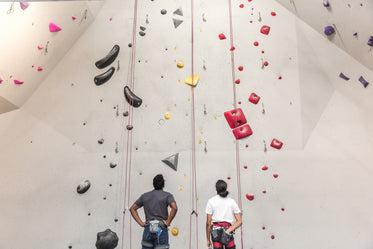 two rock climbers plan their route together