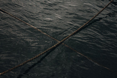 two ropes crossing over on the water
