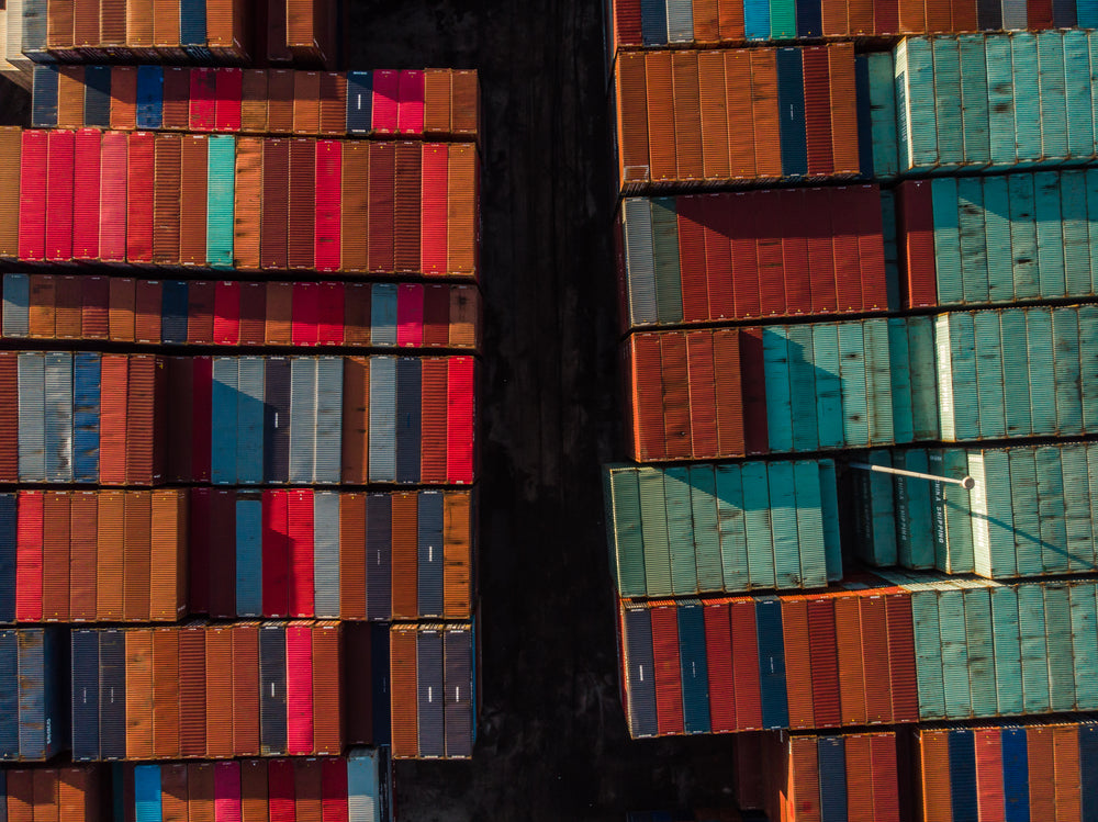 two rows of shipping containers taken with a drone